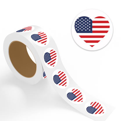 "4th of July stickers roll with USA flag heart design, shown with enlarged circular sticker preview in red, white, and blue."
