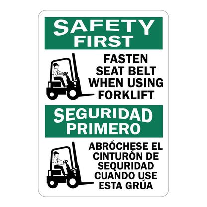 Bilingual white and green SAFETY FIRST sign sticker with forklift operator graphics reading "FASTEN SEAT BELT WHEN USING FORKLIFT" in English and "SEGURIDAD PRIMERO — ABRÓCHESE EL CINTURÓN DE SEGURIDAD CUANDO USE ESTA GRÚA" in Spanish, for warehouse and industrial safety use.