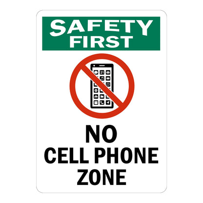 Safety First No Cell Phone Zone sign sticker with green header and prohibition icon over a phone, a workplace decal marking areas where phone use is not allowed