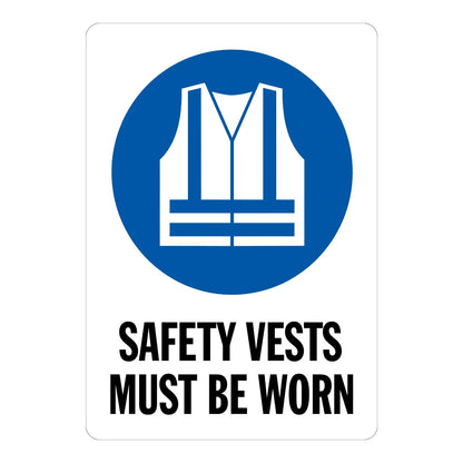 Safety Vests Must Be Worn Sign Sticker – white sign with a blue safety vest icon and bold black text stating that safety vests must be worn
