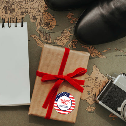 Gift wrapped in brown paper with Thank You Sticker – American Flag Design with a red ribbon on a world map background