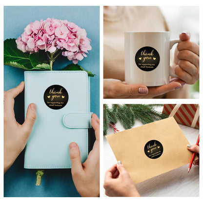 Collage of a light blue notebook, white mug with a gold Thank You Sticker – Black & Gold Design sticker, and a brown envelope with a gold 'thank you' sticker.