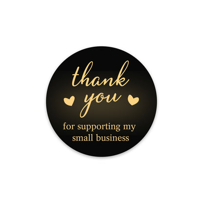 Round black sticker with gold text 'thank you for supporting my small business' on a white background