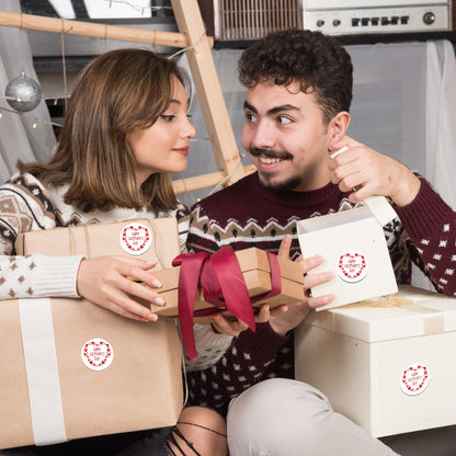 Two people exchanging Valentine’s Day Sticker – Happy Valentine Heart Frame Design on gifts with festive wrapping and ribbons.