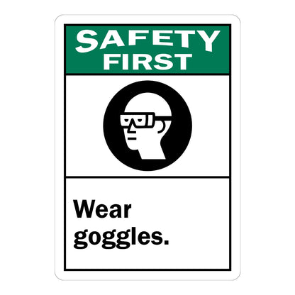 Safety First Wear Goggles ANSI sign in green black and white featuring a safety glasses icon for labs workshops and industrial safety zones
