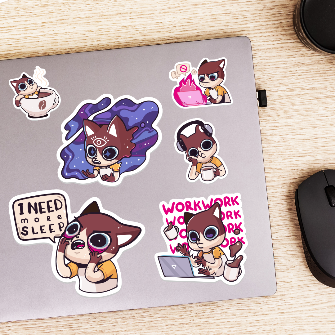 Set of cartoon custom shape vinyl stickers on a mouse pad with a mouse on a wooden surface.